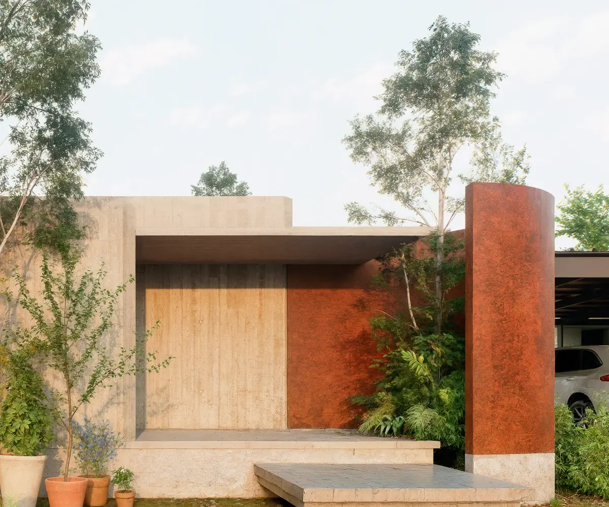 Acceso de Casa Junquillar con volúmenes de acero corten y travertino