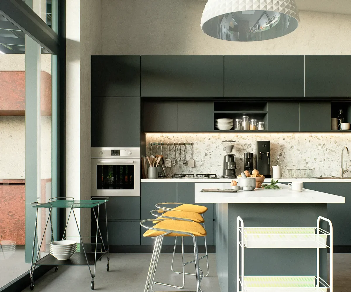 Cocina con isla, muebles verde profundo y mesón de piedra